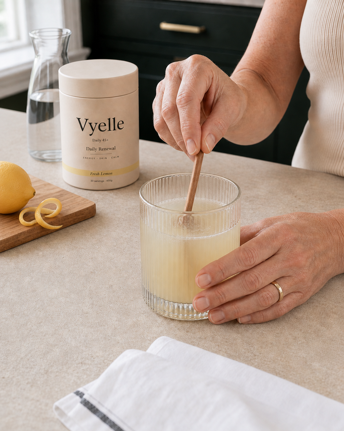 Hands stirring the prepared Vyelle drink in a ribbed glass.